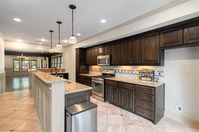 422 S Winnetka Ave, Dallas, TX 75208 - kitchen with stainless steel appliances, a sink, backsplash, crown molding, and dark brown cabinetry