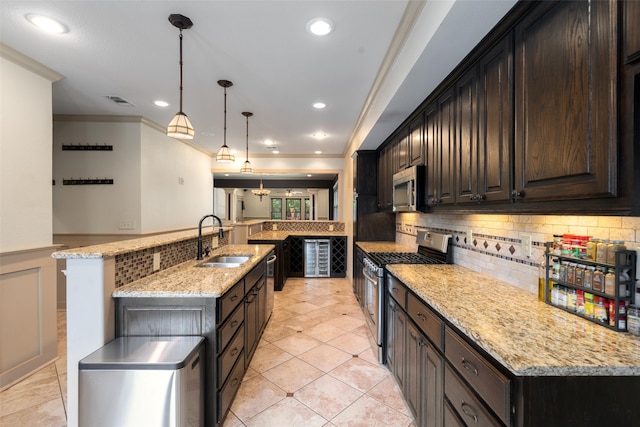 422 S Winnetka Ave, Dallas, TX 75208 - kitchen featuring appliances with stainless steel finishes, a sink, an island with sink, tasteful backsplash, and ornamental molding