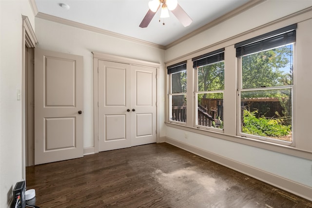 422 S Winnetka Ave, Dallas, TX 75208 - unfurnished bedroom with multiple windows, dark wood-style flooring, crown molding, baseboards, and a closet