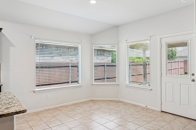 10004 Huntersville Trl, Fort Worth, TX 76108 - unfurnished dining area featuring baseboards, light tile patterned floors, and vaulted ceiling