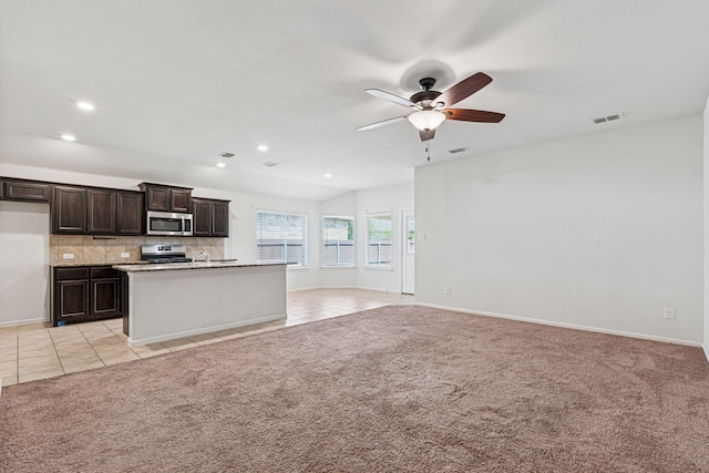 10004 Huntersville Trl, Fort Worth, TX 76108 - kitchen with stainless steel appliances, ceiling fan, open floor plan, tasteful backsplash, and light tile patterned floors
