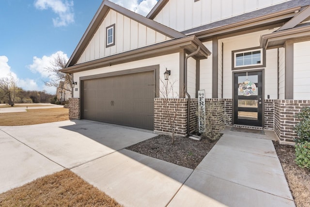 view of side of home featuring board and batten siding, driveway, brick siding, and a garage