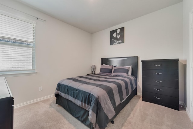 bedroom with baseboards and carpet floors