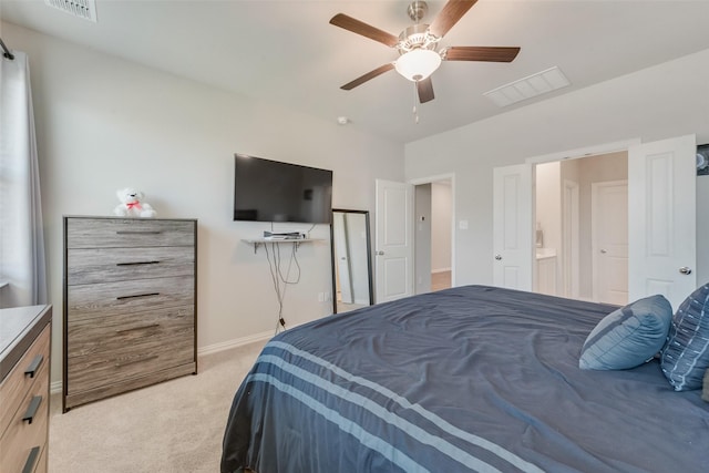 bedroom with light colored carpet, visible vents, baseboards, and a ceiling fan