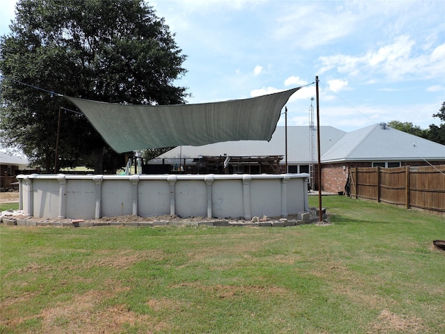 view of yard with an outdoor pool and fence