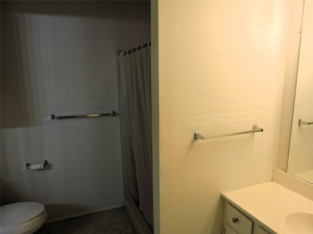 bathroom with baseboards, toilet, vanity, a shower with curtain, and tile patterned flooring