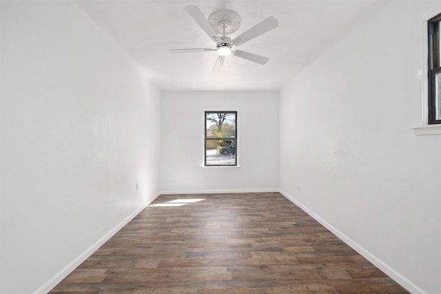 empty room featuring baseboards, ceiling fan, and wood finished floors