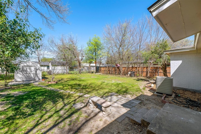 view of yard featuring a fenced backyard, a storage unit, cooling unit, an outdoor structure, and a patio area