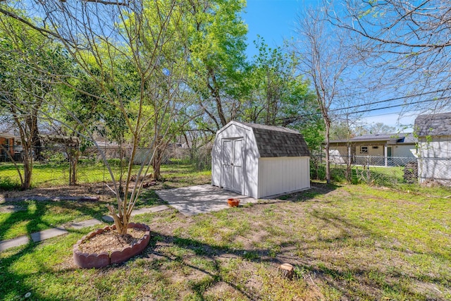 view of yard featuring a fenced backyard, a shed, and an outbuilding