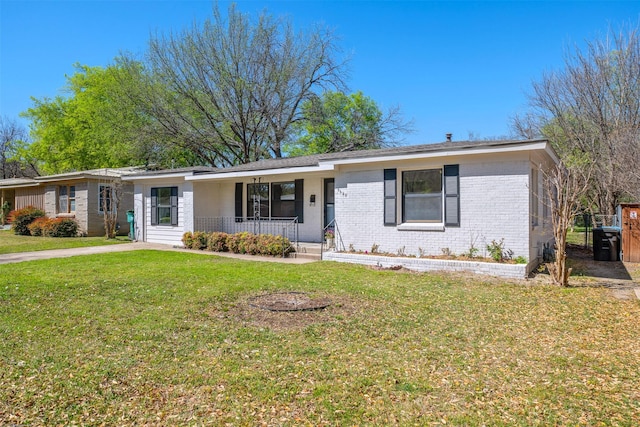 ranch-style house featuring brick siding, a front lawn, and a porch