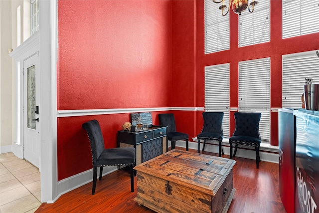 living area with baseboards, wood finished floors, and a baseboard radiator