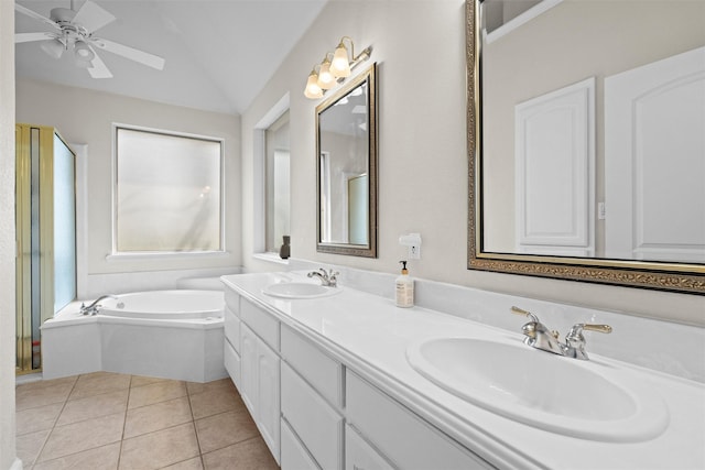 bathroom featuring lofted ceiling, tile patterned flooring, a sink, and a garden tub