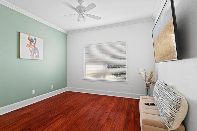 living area with a ceiling fan, crown molding, baseboards, and wood finished floors