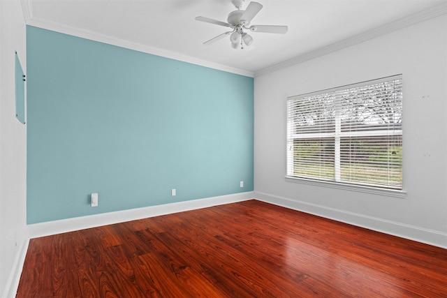 empty room with baseboards, ornamental molding, and wood finished floors