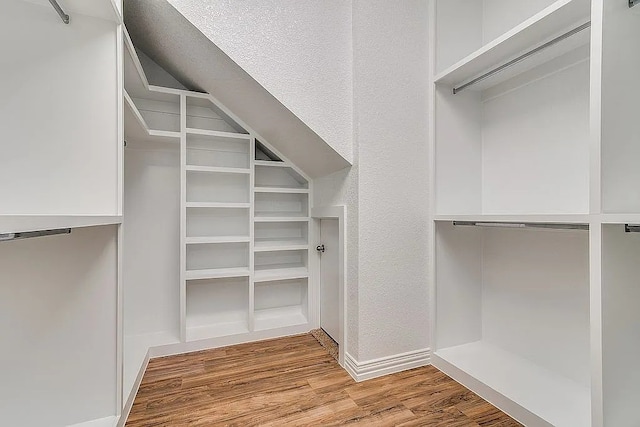 4726 Steeple Chase Ln, Rockwall, TX 75032 - walk in closet featuring wood finished floors and vaulted ceiling