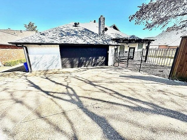 4726 Steeple Chase Ln, Rockwall, TX 75032 - view of property exterior featuring a garage and a chimney