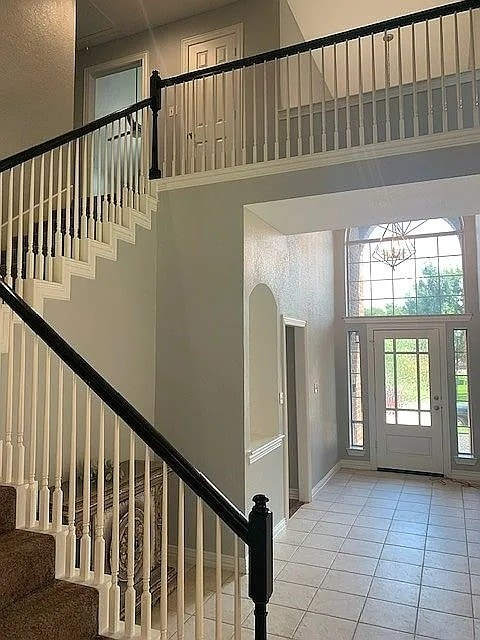 4726 Steeple Chase Ln, Rockwall, TX 75032 - foyer featuring a high ceiling, stairway, and tile patterned floors
