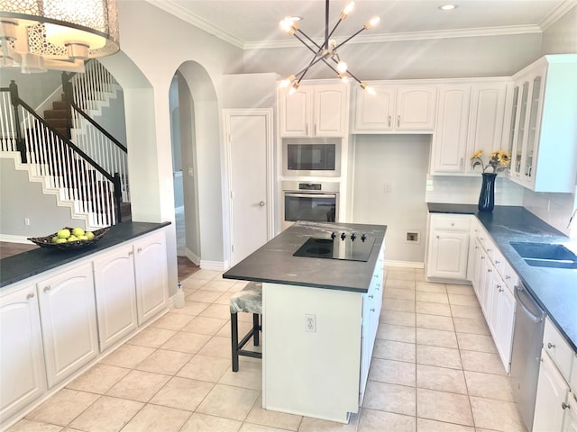 4726 Steeple Chase Ln, Rockwall, TX 75032 - kitchen with stainless steel appliances, dark countertops, light tile patterned floors, white cabinetry, and crown molding
