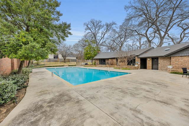 view of pool with a fenced in pool, fence, and a patio