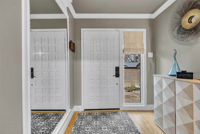 entrance foyer with baseboards, crown molding, and light wood-style flooring