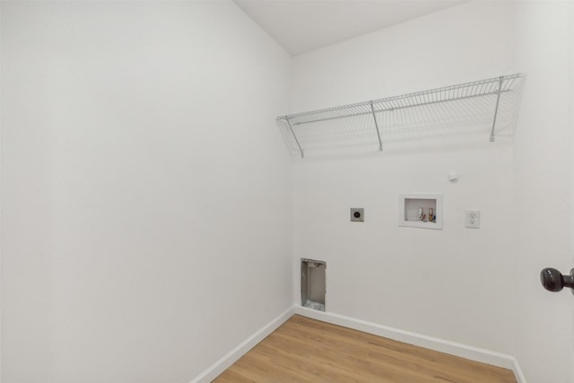 laundry room with hookup for a washing machine, baseboards, laundry area, light wood-style floors, and electric dryer hookup