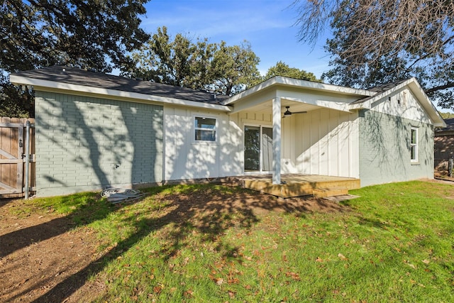 back of property featuring fence, brick siding, a patio, ceiling fan, and a yard