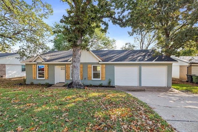 single story home with brick siding, a front yard, driveway, and an attached garage