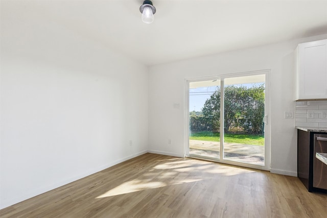 unfurnished living room featuring baseboards, a fireplace, and light wood-style floors