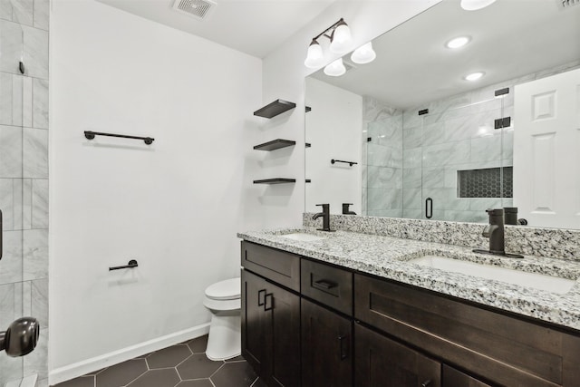 full bath featuring a stall shower, toilet, a sink, visible vents, and double vanity
