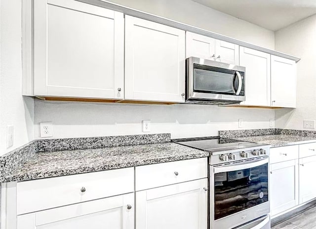 1637 Escondido Dr, Fort Worth, TX 76052 - kitchen featuring white cabinetry, light stone countertops, stainless steel appliances, and light wood finished floors
