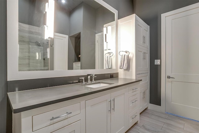 bathroom with walk in shower and vanity