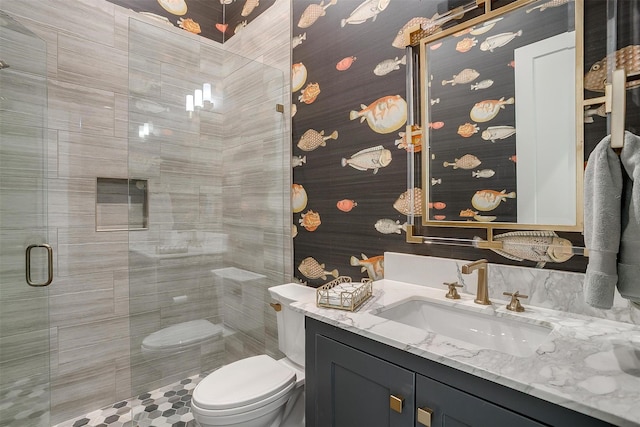 full bathroom featuring toilet, a stall shower, and vanity