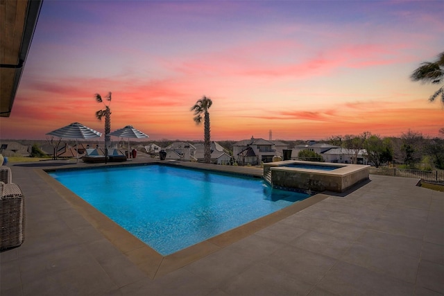 view of pool with a patio area, a pool with connected hot tub, and a residential view