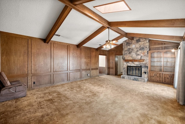 1611 Royal Mile Ct, Arlington, TX 76015 - unfurnished living room with a fireplace, carpet, ceiling fan, and wood walls