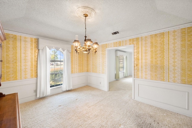 1611 Royal Mile Ct, Arlington, TX 76015 - unfurnished dining area with plenty of natural light, a chandelier, wainscoting, wallpapered walls, and carpet