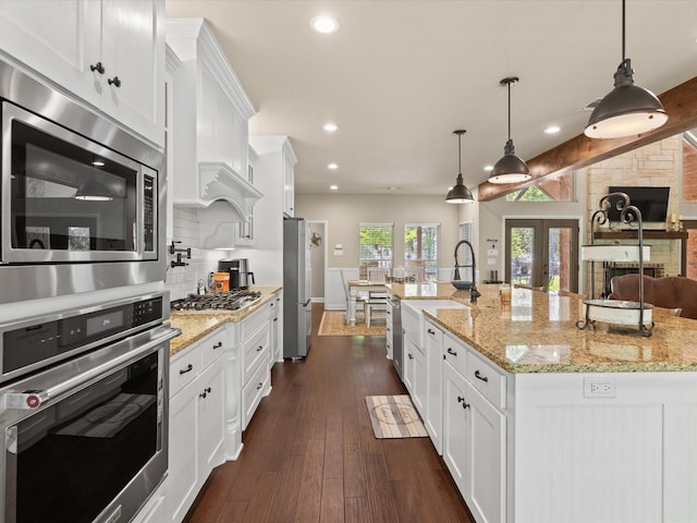 141 County Road 3481, Paradise, TX 76073 - kitchen with a sink, tasteful backsplash, recessed lighting, white cabinetry, and appliances with stainless steel finishes