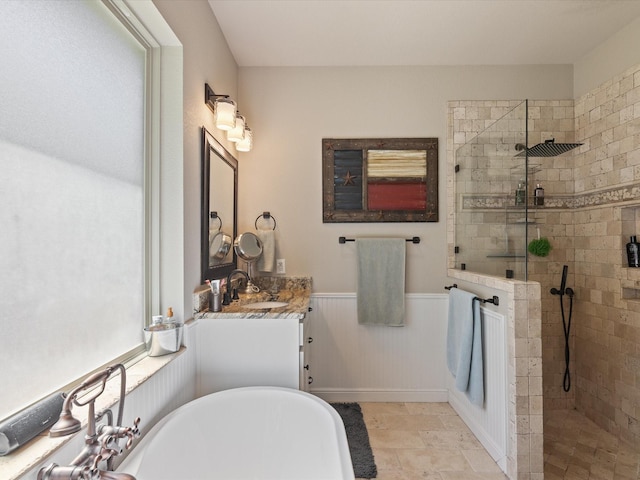 141 County Road 3481, Paradise, TX 76073 - bathroom with wainscoting, a soaking tub, walk in shower, and vanity