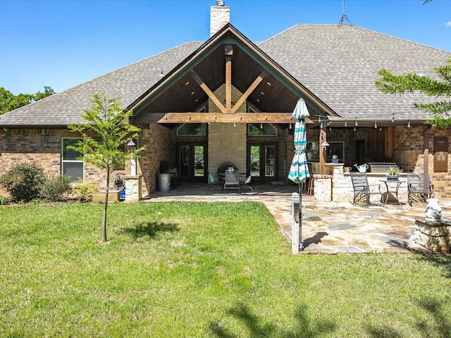 141 County Road 3481, Paradise, TX 76073 - rear view of house featuring a lawn, roof with shingles, a patio area, and brick siding