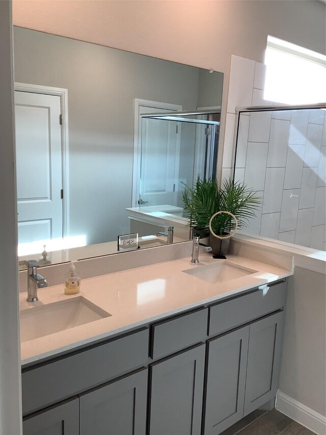 156 Hawksbill Ln, Rhome, TX 76078 - full bathroom with a stall shower, double vanity, and a sink