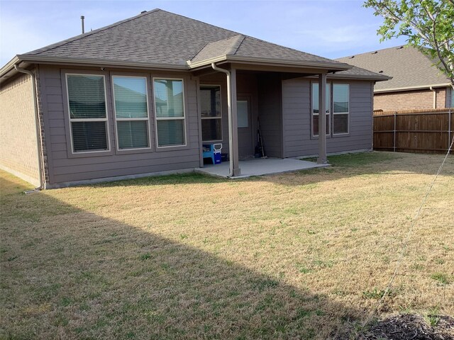 156 Hawksbill Ln, Rhome, TX 76078 - back of house featuring a patio, a shingled roof, fence, and a lawn