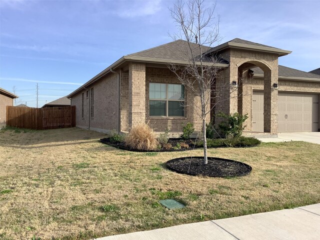 156 Hawksbill Ln, Rhome, TX 76078 - view of front of house with brick siding, fence, a front lawn, and a garage