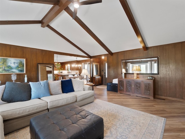 living area with wood walls, wood finished floors, and beam ceiling