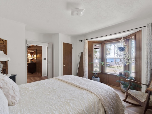 bedroom featuring wood finished floors and a textured ceiling