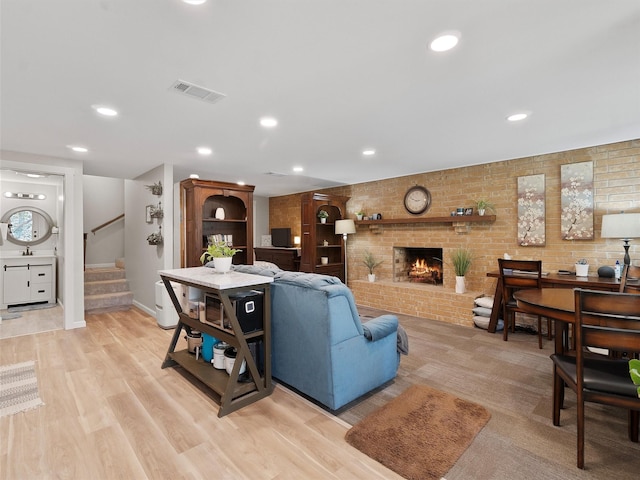 living area featuring stairs, visible vents, recessed lighting, and light wood finished floors