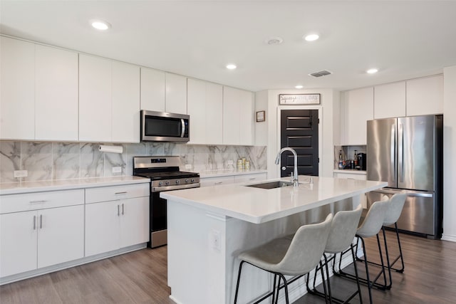 816 Adair Dr, Aubrey, TX 76227 - kitchen featuring wood finished floors, visible vents, a sink, and appliances with stainless steel finishes