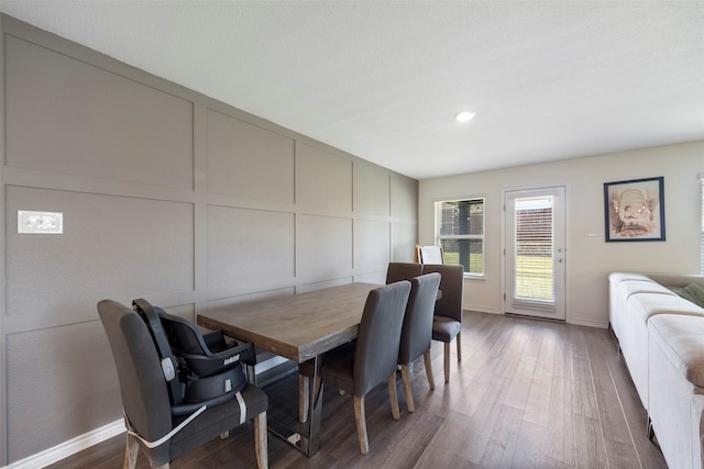 816 Adair Dr, Aubrey, TX 76227 - dining room featuring a decorative wall, wood finished floors, and baseboards