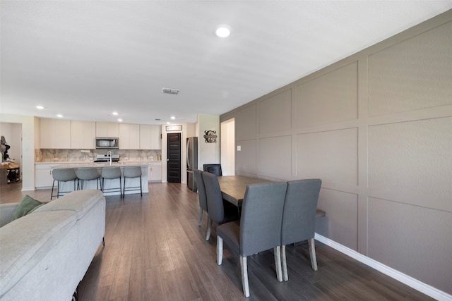816 Adair Dr, Aubrey, TX 76227 - dining area featuring recessed lighting, a decorative wall, visible vents, and dark wood finished floors