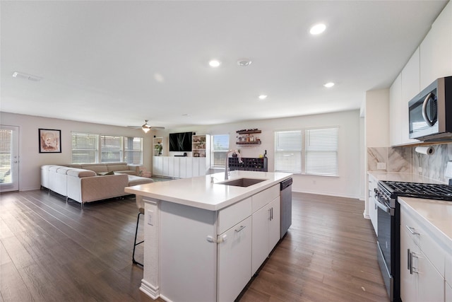 816 Adair Dr, Aubrey, TX 76227 - kitchen featuring light countertops, dark wood-type flooring, visible vents, appliances with stainless steel finishes, and a sink