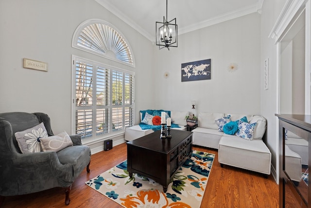 interior space featuring baseboards, ornamental molding, wood finished floors, and a notable chandelier