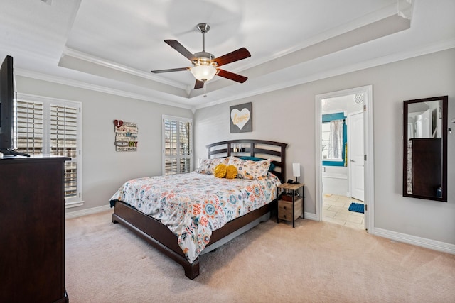 carpeted bedroom with a ceiling fan, a raised ceiling, ornamental molding, and baseboards